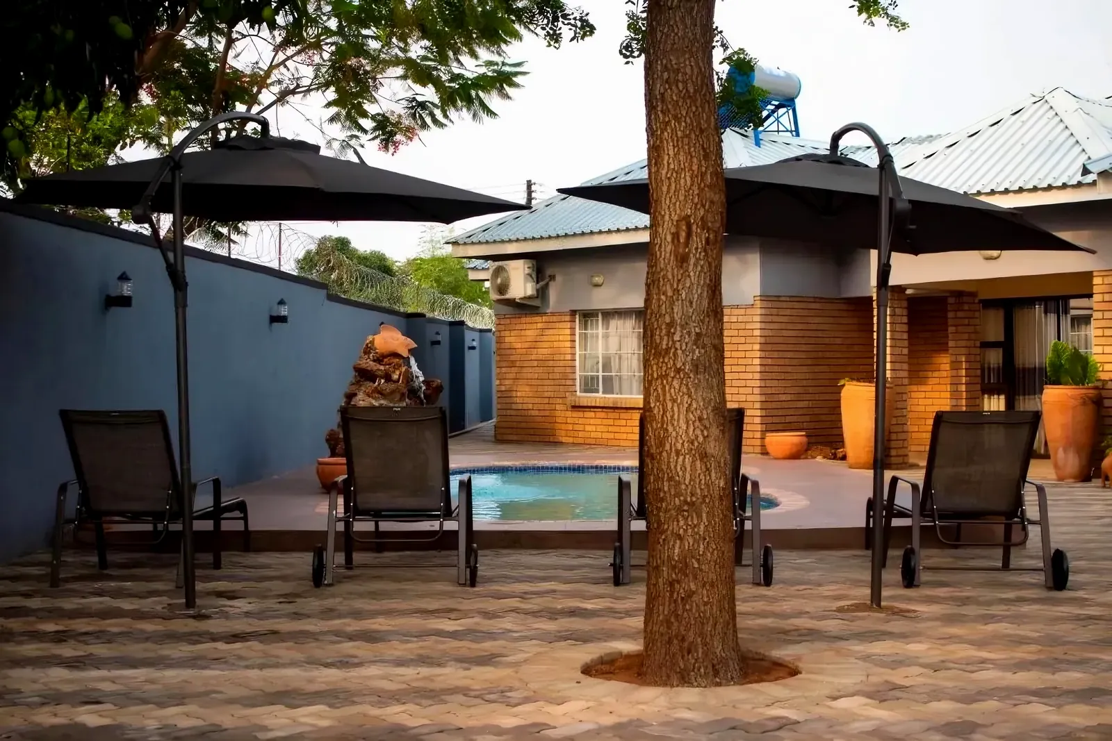 Pool courtyard with loungers and umbrellas