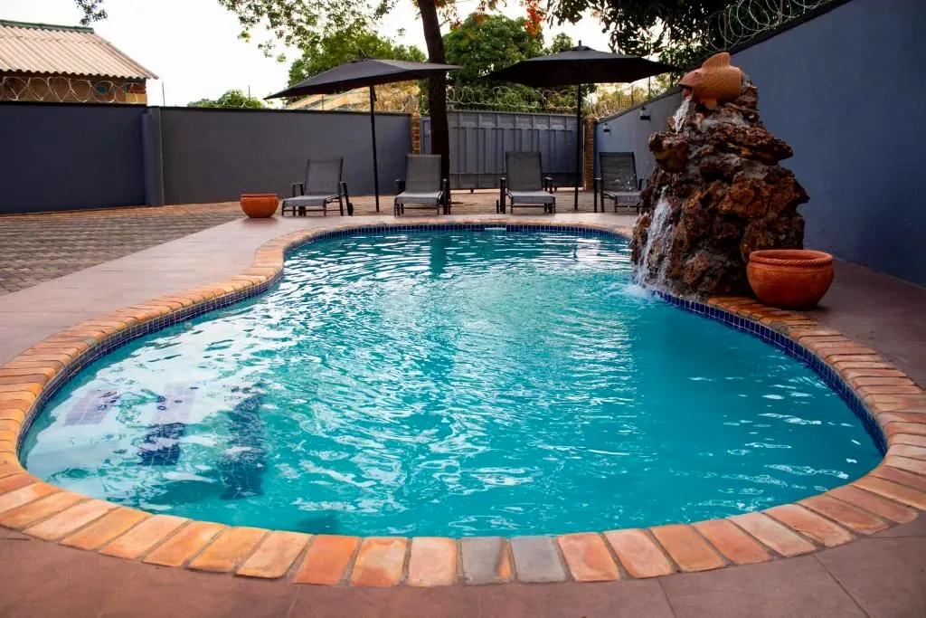 Pool with rock waterfall feature